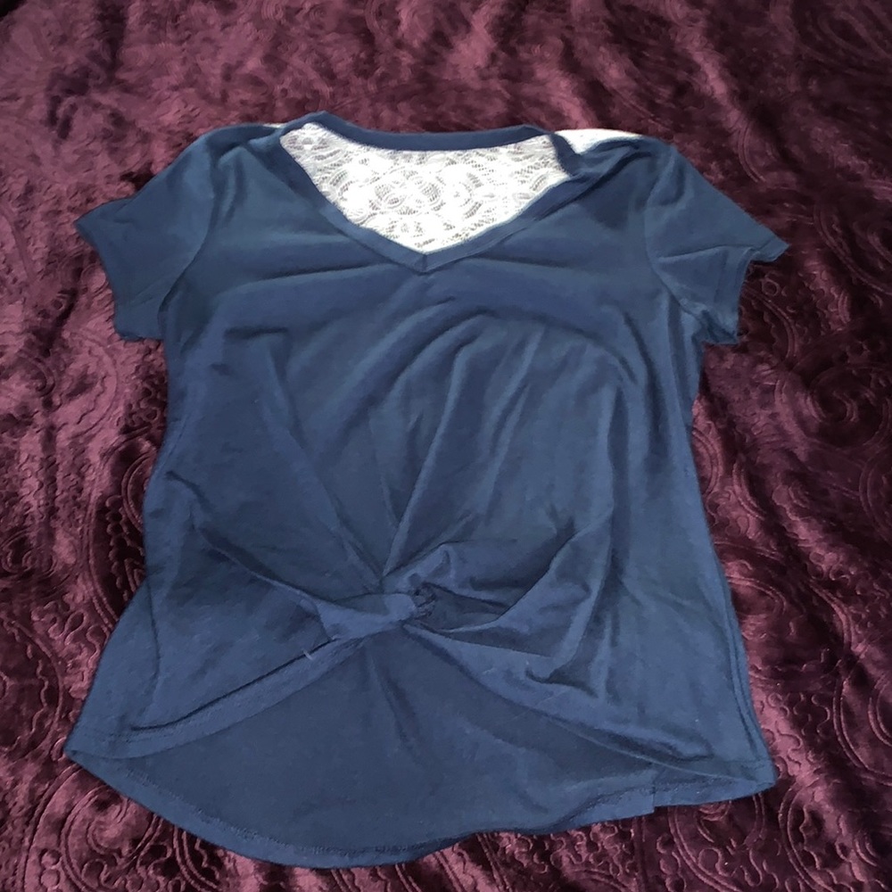 A navy blue shirt, with lace on the back.